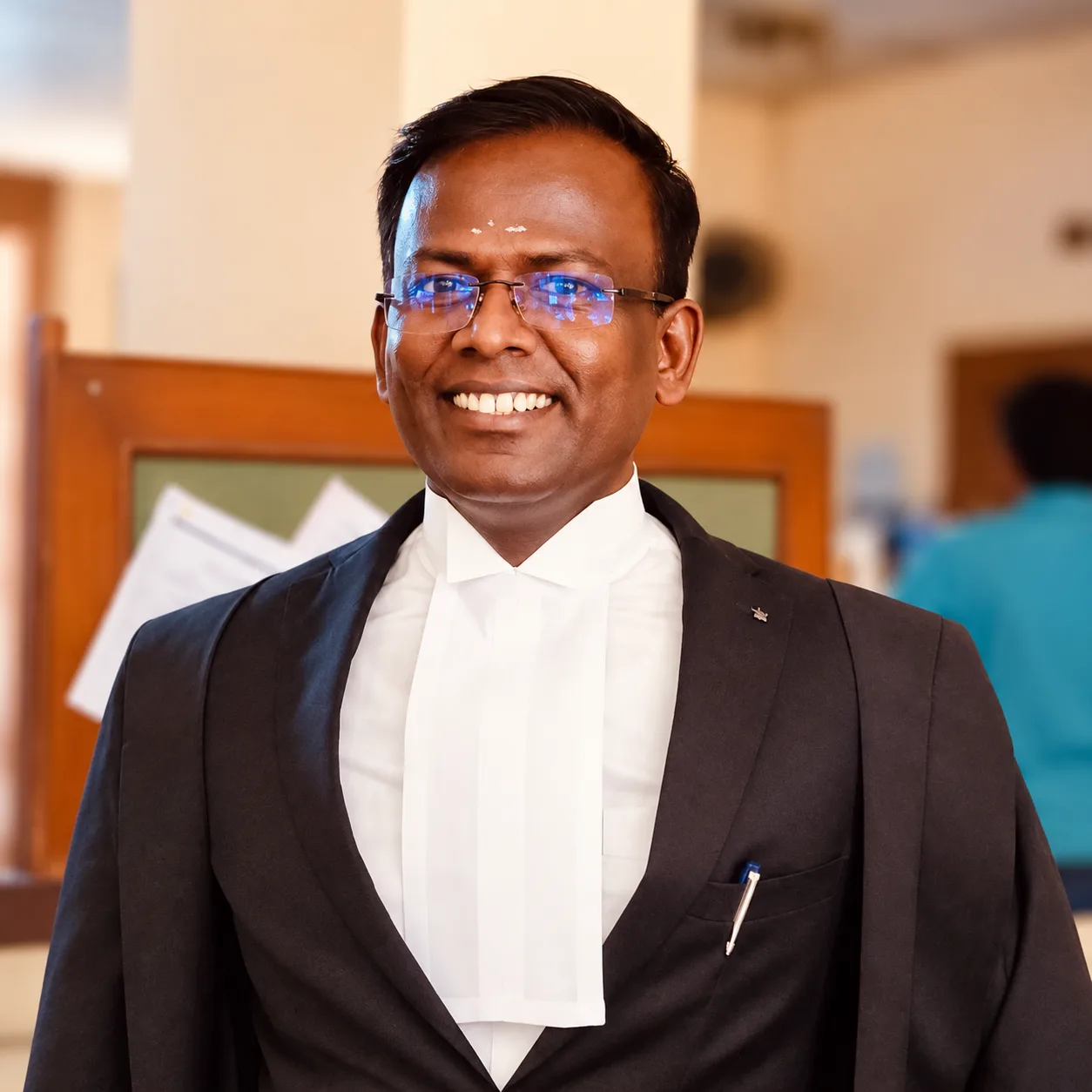 Adv. K Rajesh Kannan smiling in advocate's robes